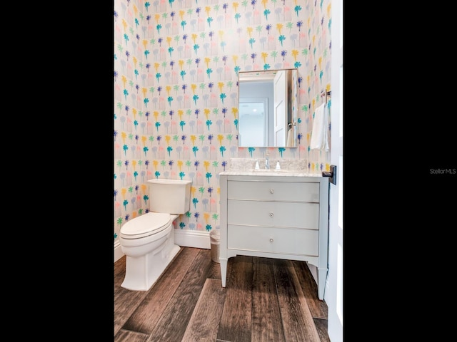 bathroom featuring hardwood / wood-style flooring, vanity, and toilet