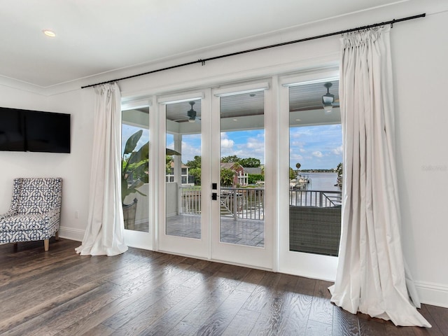 doorway to outside featuring a water view, ceiling fan, dark wood-type flooring, and french doors