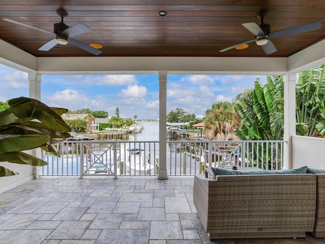 view of patio / terrace with a water view and ceiling fan