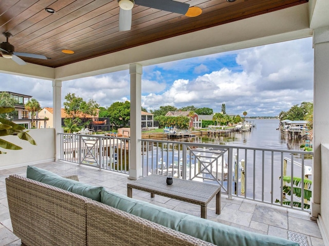 exterior space featuring an outdoor hangout area, a water view, and ceiling fan