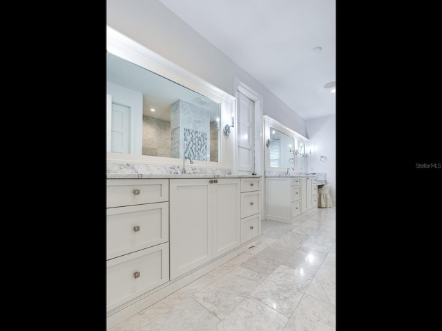 bathroom featuring walk in shower and vanity