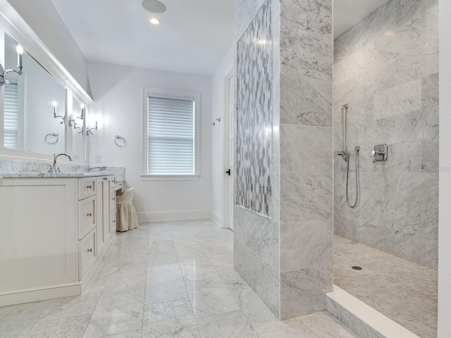 bathroom with vanity and tiled shower