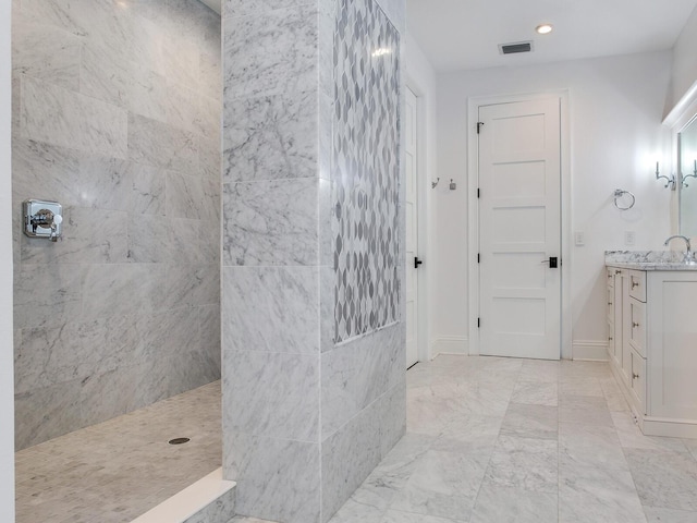 bathroom with vanity and tiled shower