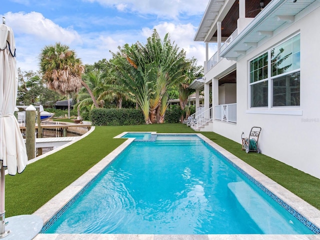 view of pool with a yard