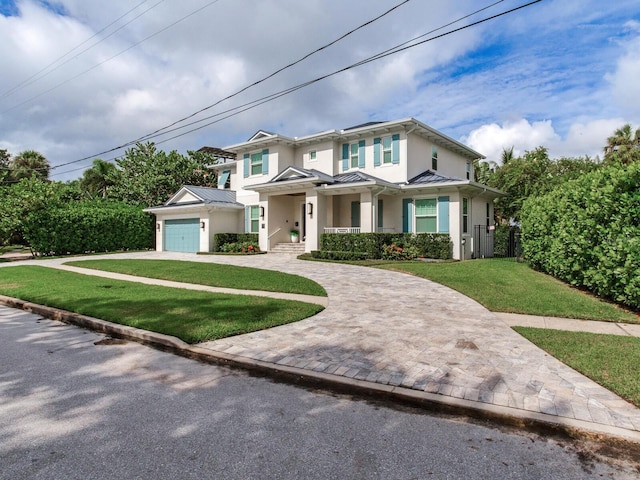 view of front of house featuring a front yard and a garage