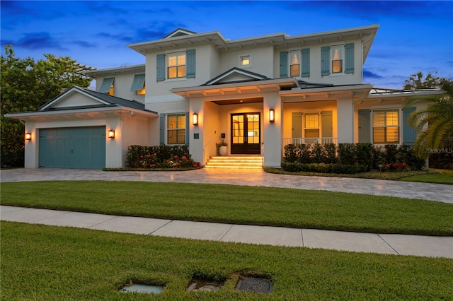 view of front facade with a lawn and a garage