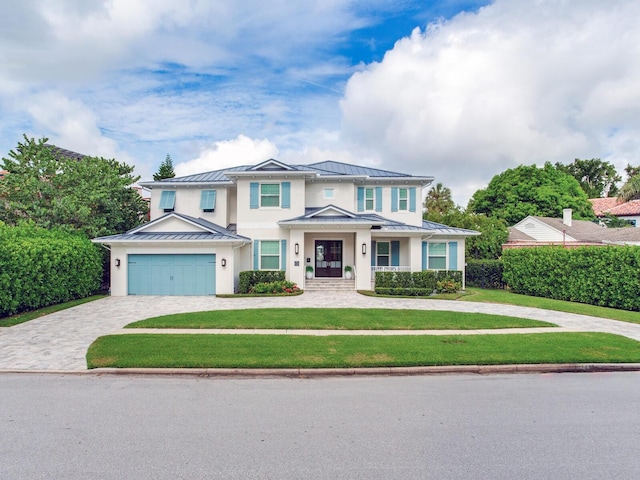 view of front of house with a front yard and a garage