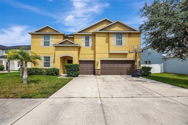 10820 Carloway Hills Dr, Wimauma, FL 33598 - view of front of home with a front lawn, concrete driveway, fence, and stucco siding