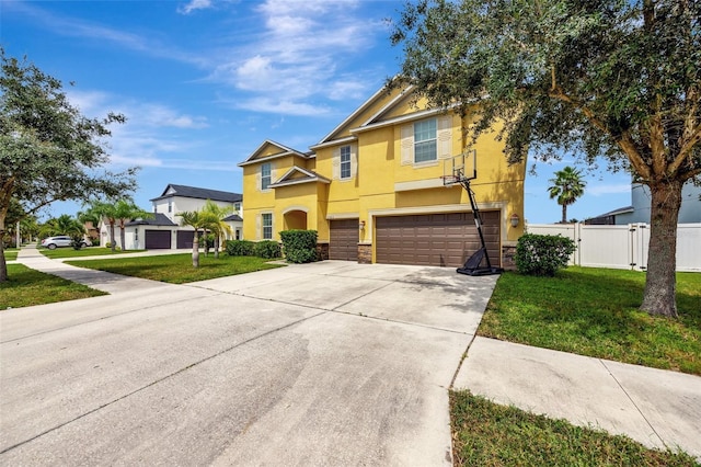 10820 Carloway Hills Dr, Wimauma, FL 33598 - view of front facade featuring fence, stucco siding, a front lawn, concrete driveway, and a garage