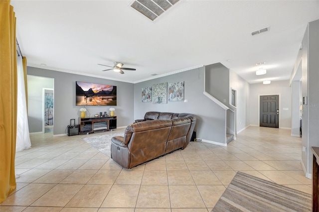 tiled living room featuring ceiling fan and crown molding