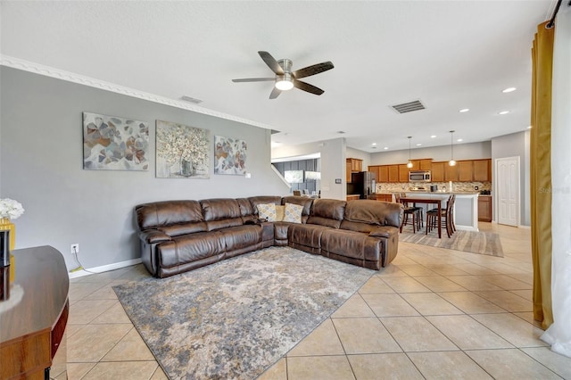 living room with ceiling fan and light tile patterned flooring