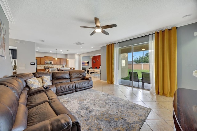 tiled living room with ceiling fan and a textured ceiling