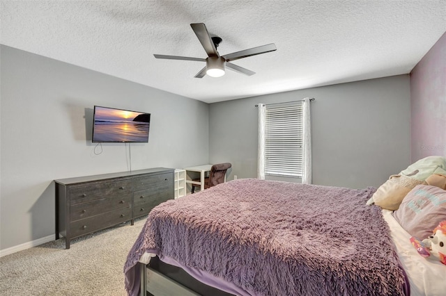 bedroom with a textured ceiling, light colored carpet, and ceiling fan