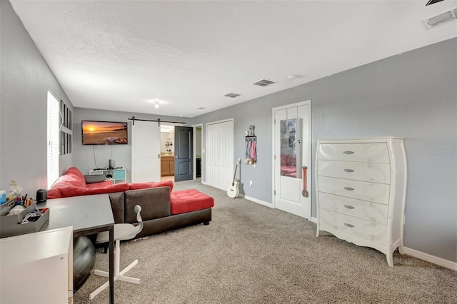 interior space featuring a barn door and carpet floors