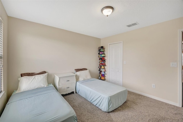 bedroom featuring light colored carpet and a closet