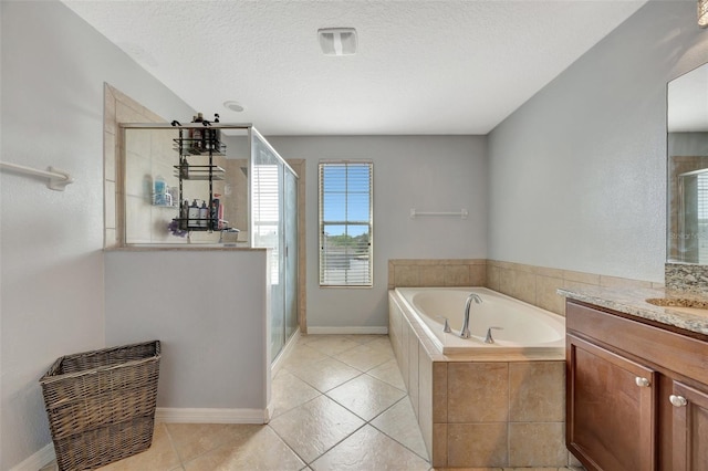 bathroom with vanity, a textured ceiling, independent shower and bath, and tile patterned flooring