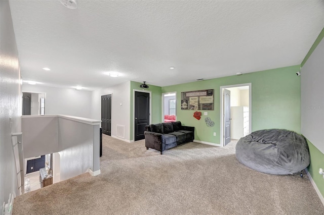 10820 Carloway Hills Dr, Wimauma, FL 33598 - living area with visible vents, an upstairs landing, a textured ceiling, baseboards, and light colored carpet