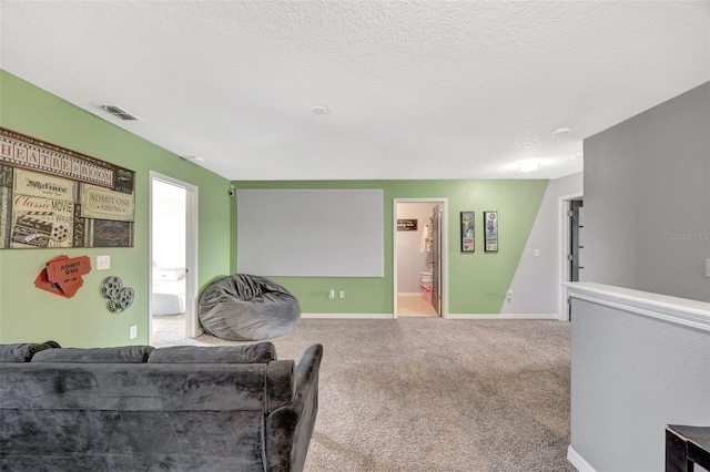 living room with a textured ceiling and light colored carpet