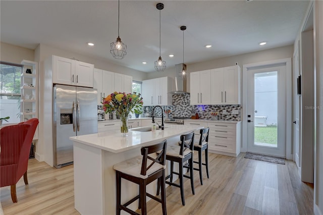 kitchen with white cabinets, a wealth of natural light, stainless steel appliances, and sink