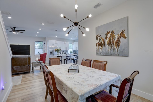 dining area with ceiling fan and light hardwood / wood-style floors