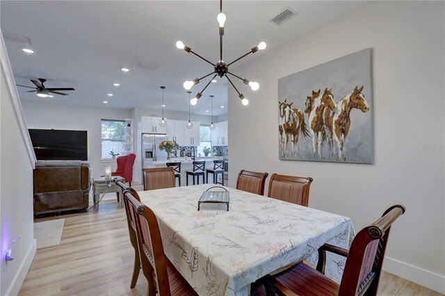 2860 14th Ave N, Saint Petersburg, FL 33713 - dining area featuring light wood-style flooring, visible vents, baseboards, recessed lighting, and ceiling fan with notable chandelier