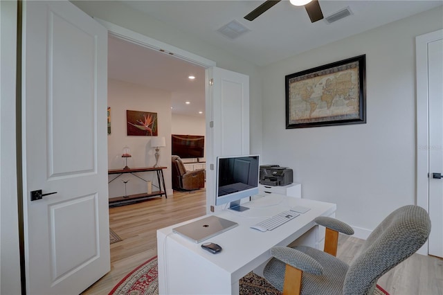 home office featuring light wood-type flooring and ceiling fan