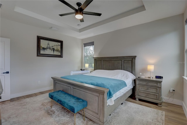 2860 14th Ave N, Saint Petersburg, FL 33713 - bedroom with a tray ceiling, light wood-style flooring, baseboards, visible vents, and ceiling fan