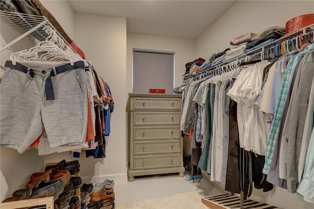 walk in closet with light tile patterned floors