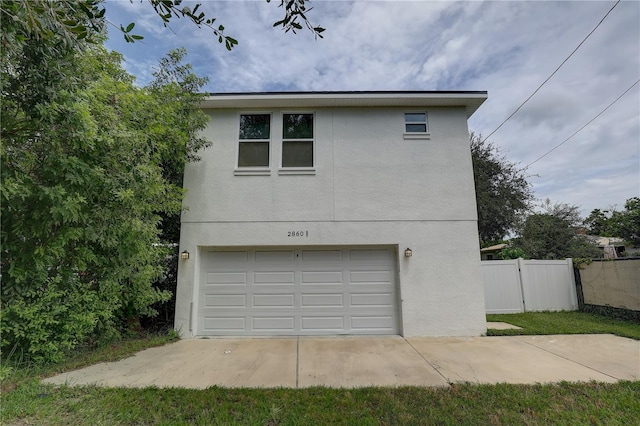 2860 14th Ave N, Saint Petersburg, FL 33713 - exterior space with stucco siding, fence, and an attached garage