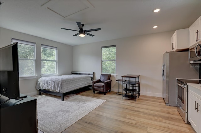 bedroom with ceiling fan, light wood-type flooring, and multiple windows