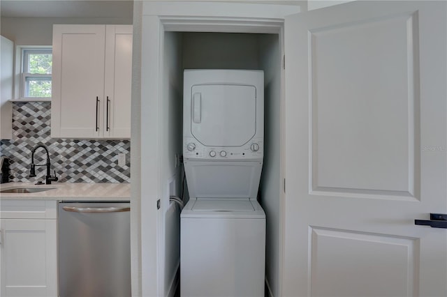 clothes washing area with sink and stacked washer / dryer