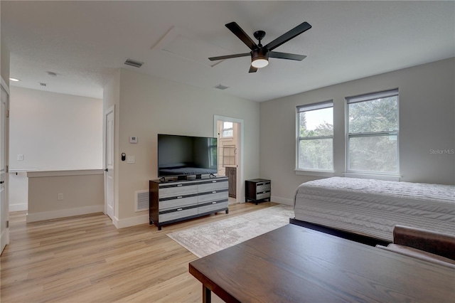 bedroom with ceiling fan and light hardwood / wood-style floors