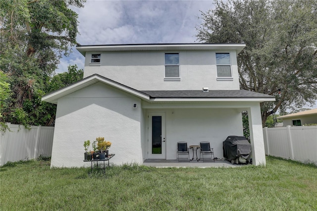 rear view of property with a patio area and a yard