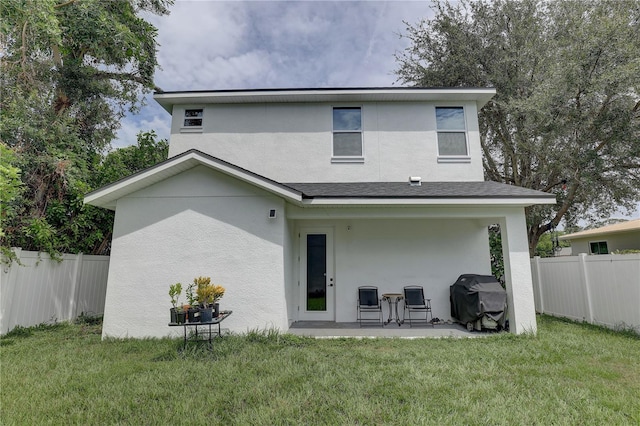 2860 14th Ave N, Saint Petersburg, FL 33713 - back of property with stucco siding, fence, a patio, and a yard