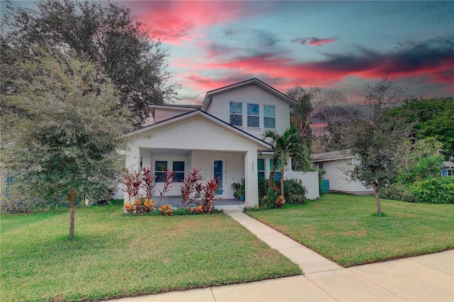 view of front of property featuring a porch and a yard