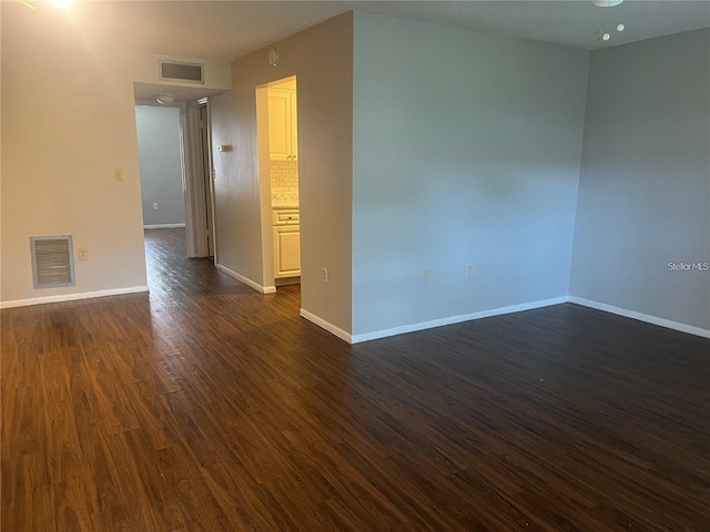 empty room featuring dark hardwood / wood-style flooring