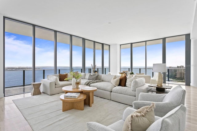 living room with a water view and expansive windows