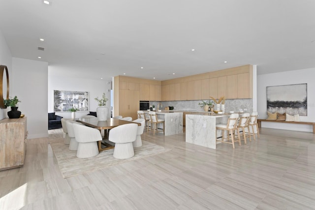 dining space with light hardwood / wood-style flooring