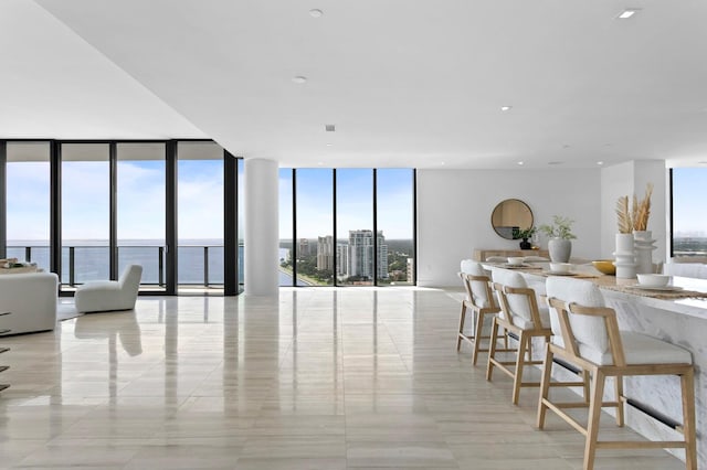 dining room featuring a water view and floor to ceiling windows