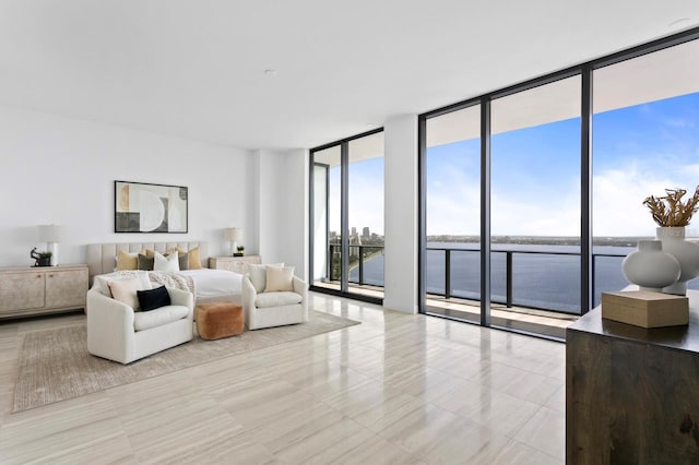 living room with a water view and floor to ceiling windows