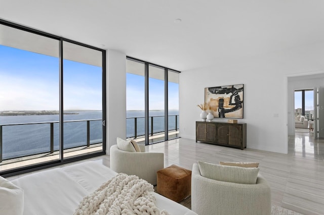 bedroom with a water view and a wall of windows