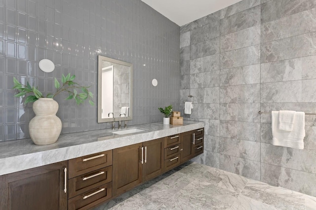 bathroom featuring vanity and tile walls