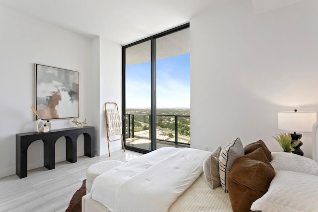 bedroom featuring access to outside and expansive windows