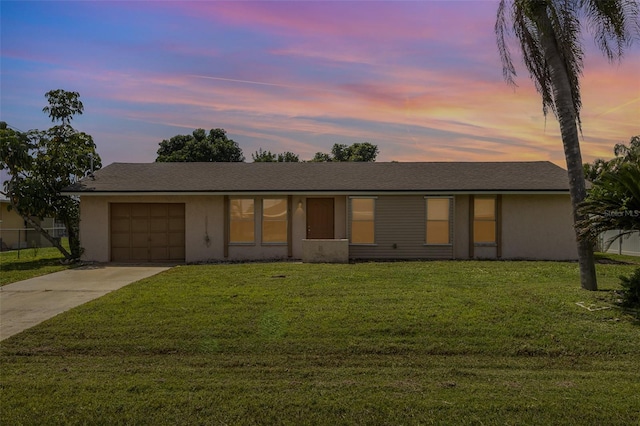 single story home with a yard and a garage