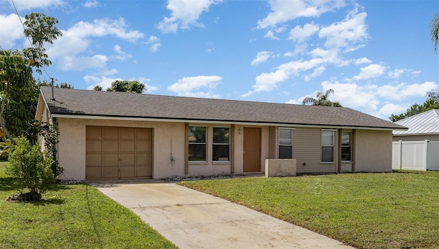 single story home featuring a garage and a front lawn