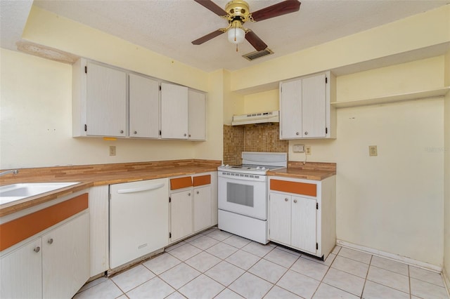 kitchen featuring white appliances, ceiling fan, light tile patterned floors, a textured ceiling, and white cabinetry