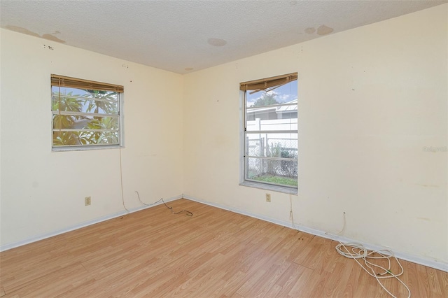 empty room featuring light hardwood / wood-style flooring and a textured ceiling