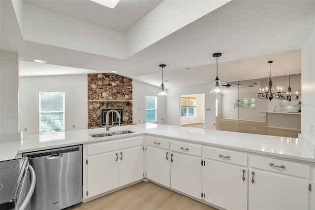 kitchen with appliances with stainless steel finishes, lofted ceiling, sink, and plenty of natural light