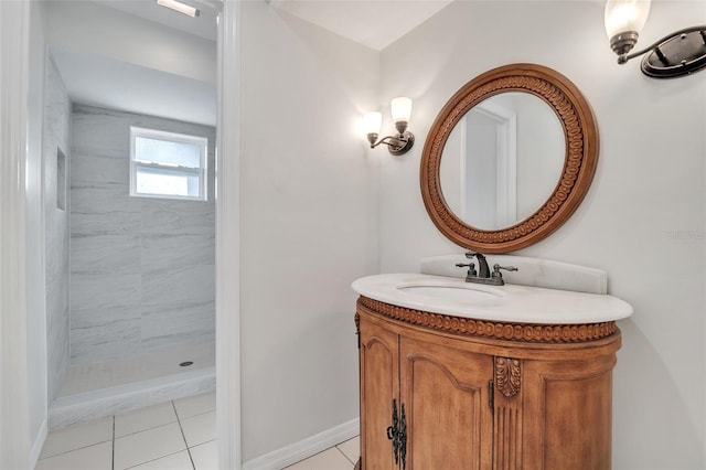 bathroom with tile patterned flooring, vanity, and tiled shower