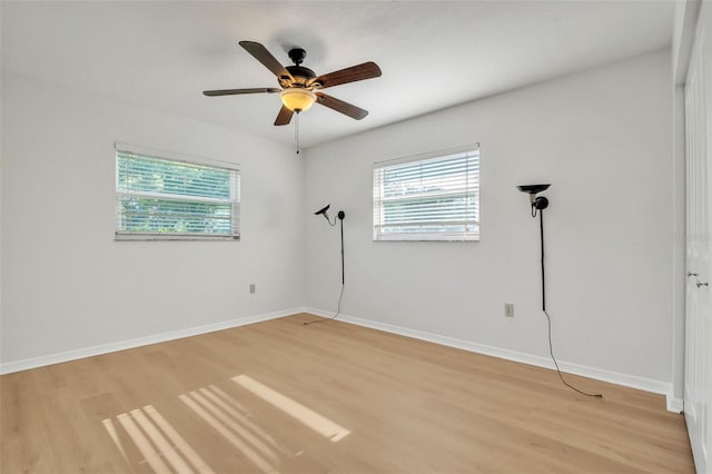 empty room with light wood-type flooring and ceiling fan